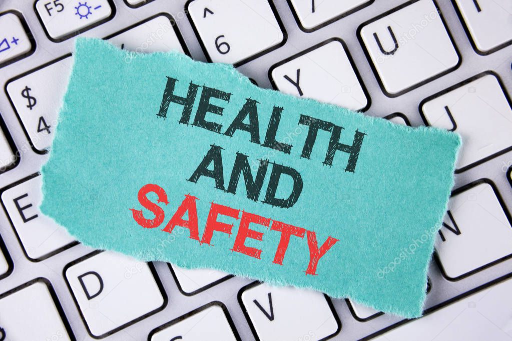 Handwriting text writing Health And Safety. Concept meaning being in good condition harmless Workouts Healthy food written on tear Sticky Note Paper placed on the Laptop.