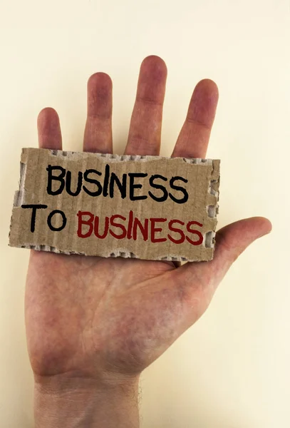 Writing note showing  Business To Business. Business photo showcasing Working ground businessman busy work hard stop playing written on Tear Cardboard Piece placed on Hand on the plain background. — Stock Photo, Image