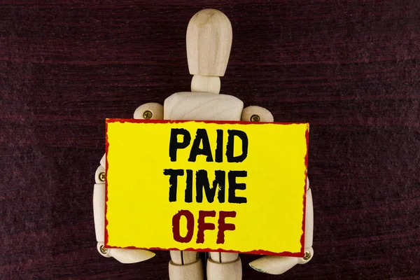 Word writing text Paid Time Off. Business concept for vacation with full payment take vacation Resting Healing written on Sticky note paper holding by Wooden Robot Toy on wooden background.
