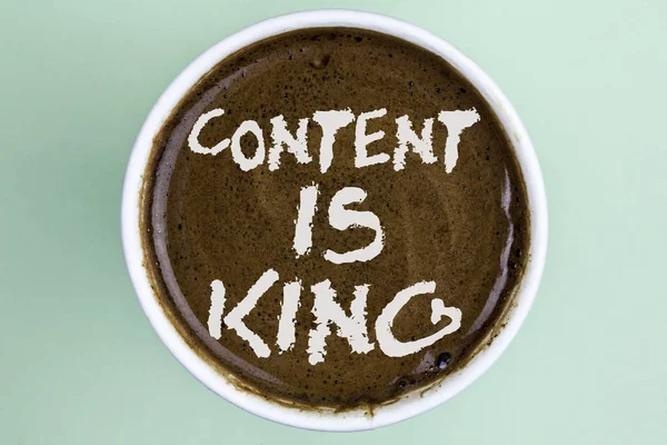 Writing note showing  Content Is King. Business photo showcasing articles or posts can guarantee you success Advertising written on Coffee in a Cup on the plain background.