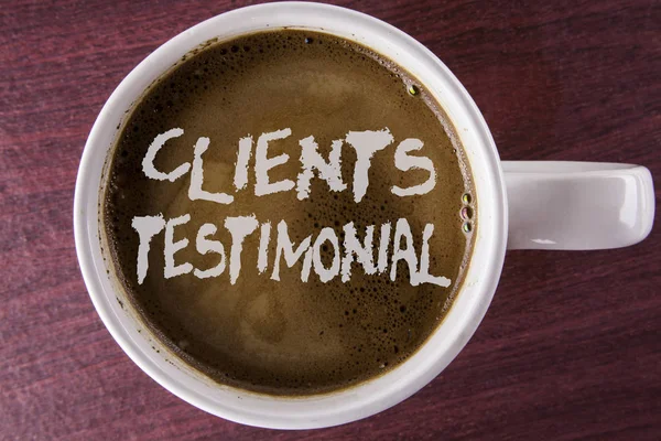 Writing note showing  Clients Testimonial. Business photo showcasing Customers Personal Experiences Reviews Opinions Feedback written on Coffee in White Cup on the wooden background.