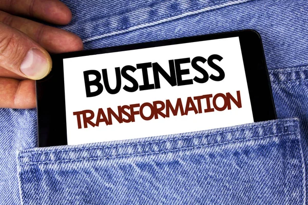 Conceptual hand writing showing Business Transformation. Business photo text Making changes in conduction of the company Upgrade written on Mobile phone holding by man on the Jeans background.