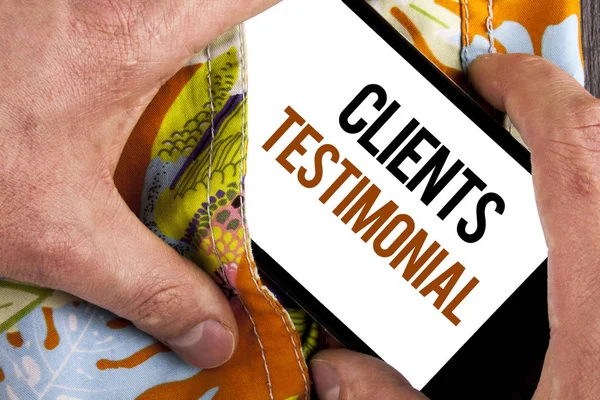 Writing note showing  Clients Testimonial. Business photo showcasing Customers Personal Experiences Reviews Opinions Feedback written on Mobile Screen holding by man on the printed background.
