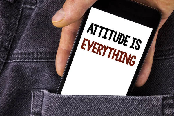 Conceptual hand writing showing Attitude Is Everything. Business photo text Motivation Inspiration Optimism important to succeed written on Mobile Phone holding by man on the Jeans background. — Stock Photo, Image