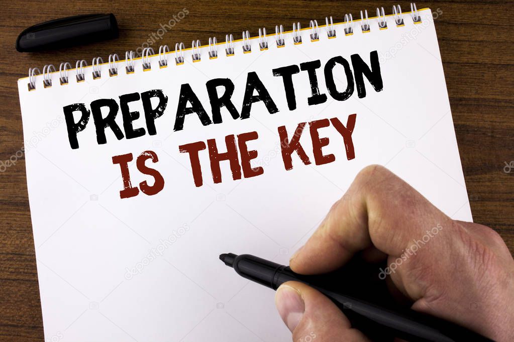 Word writing text Preparation Is The Key. Business concept for Learn Study Prepare yourself for achieving success written by Man on Notepad holding Marker on the Wooden background.