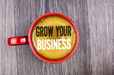Grow Your iş gösterilen not yazma. İş fotoğraf vitrine kahve kırmızı Kupası'nda gri ahşap arka plan üzerinde yazılı iş Büyüt üstesinden şirket rakiplerinizin geliştirmek. Üstten Görünüm.