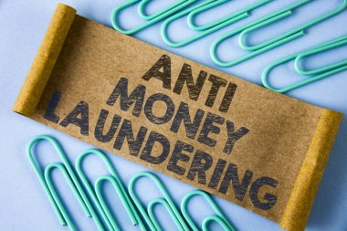 Text sign showing Anti Monay Laundring. Conceptual photo entering projects to get away dirty money and clean it written on Folded Cardboard paper piece on plain blue background within Paper Pins. clipart