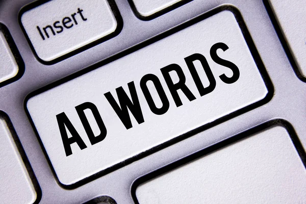 Text sign showing Ad Words. Conceptual photo Advertising a business over first of internet search results written on White Keyboard Key with copy space. Top view. — Stock Photo, Image