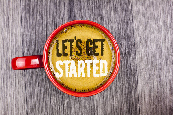 Writing note showing  Lets Get Started. Business photo showcasing beginning time motivational quote Inspiration encourage written on Coffee in Red Cup on the Grey wooden background. Top view.