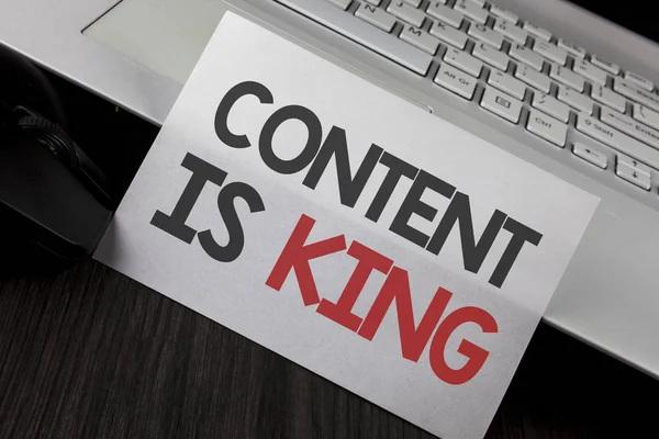 Writing note showing  Content Is King. Business photo showcasing articles or posts can guarantee you success Advertising written on White Sticky Note Paper placed on wooden Table Laptop Mouse