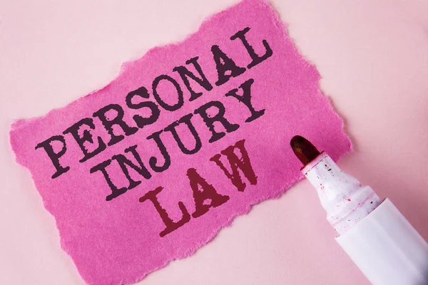 Word writing text Personal Injury Law. Business concept for guarantee your rights in case of hazards or risks written on Tear Pink Sticky note paper on Pink background Marker next to it.