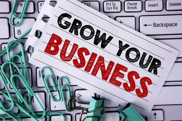 Writing note showing  Grow Your Business. Business photo showcasing improve your work enlarge company overcome competitors written on Tear Notepad paper placed on Keyboard Clips and Paper Pins.