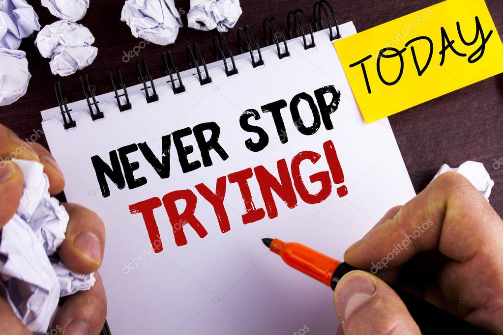 Handwriting text Never Stop Trying Motivational Call. Concept meaning go on do not give up Self confidence written by Man on Notepad on wooden background Today Paper Balls.
