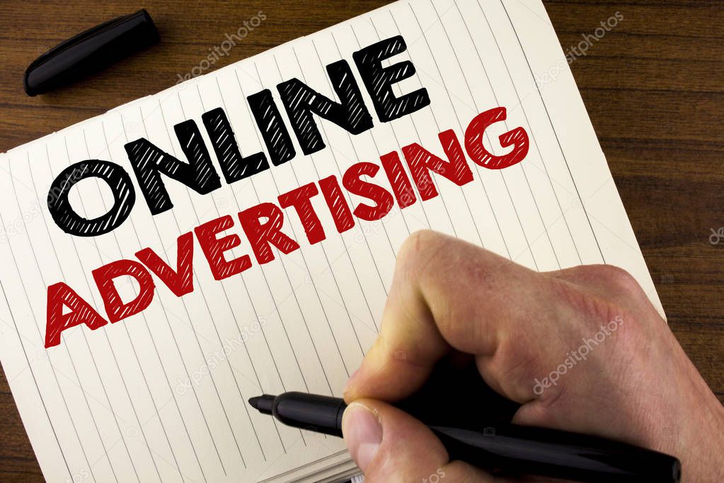 Conceptual hand writing showing Online Advertising. Business photo showcasing website campaigns Ads electronic marketing SEO Reaching written by Man on Notebook Book on Wooden background Marker.
