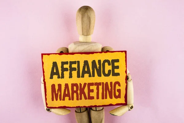 Conceptual hand writing showing Affiance Marketing. Business photo text joining two or more companies in same field mutual goal written on Sticky note paper Wooden Robot Toy plain background.