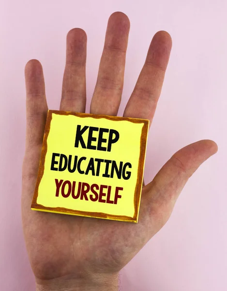 Word writing text Keep Education Yourself. Business concept for never stop learning to be better Improve encourage written on Sticky Note Paper placed on the Hand on the plain background. — Stock Photo, Image
