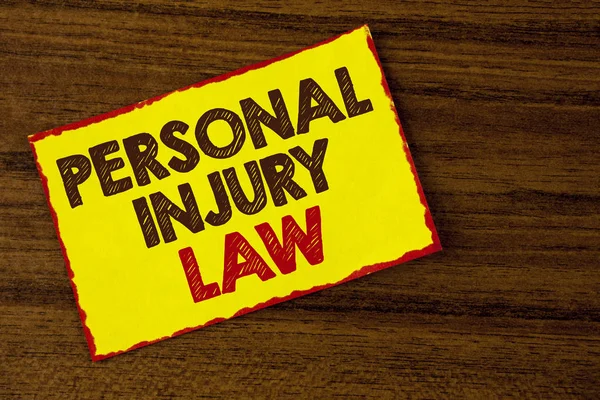 Handwriting text writing Personal Injury Law. Concept meaning guarantee your rights in case of hazards or risks written on Yellow Sticky note paper on the wooden background. — Stock Photo, Image