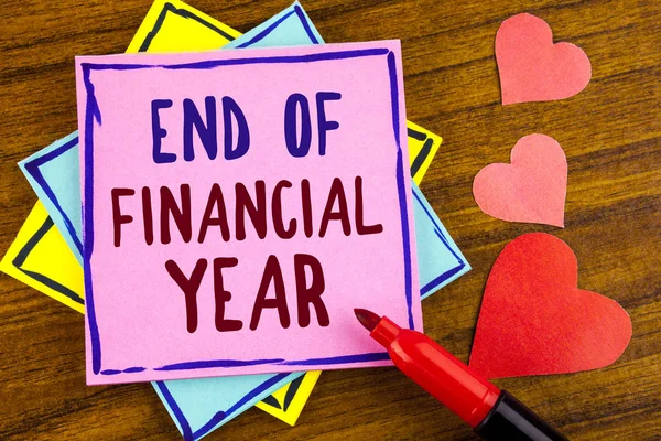 Conceptual hand writing showing End Of Financial Year. Business photo text Taxes time accounting June database cost Sheets written on Sticky note paper on wooden background Marker and Hearts — Stock Photo, Image