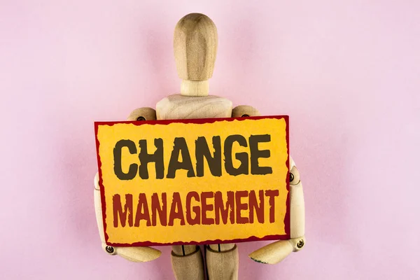 Conceptual hand writing showing Change Management. Business photo text replace leaderships or People in charge Replacement written on Sticky note paper Wooden Robot Toy plain background.