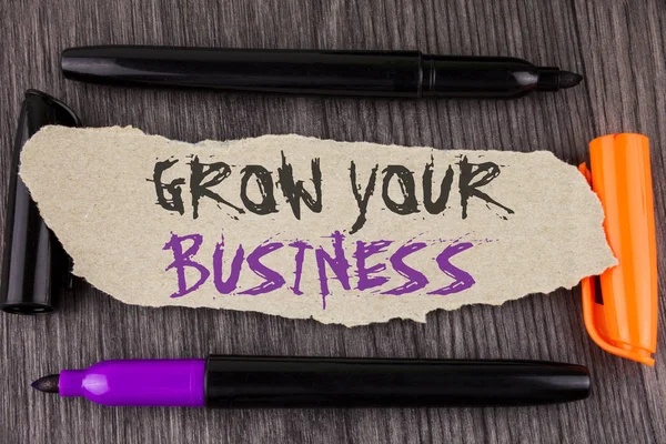 Szöveg jel mutatja az Ön üzleti növekedését. Fogalmi fénykép javítja a munka nagyítása cég leküzdeni a versenytársak a fából készült háttér markerek mellette könny karton papírra írt. — Stock Fotó