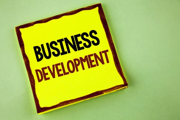 Writing note showing  Business Development. Business photo showcasing Develop and Implement Organization Growth Opportunities written on Yellow Sticky note paper on plain background. — Stock Photo, Image