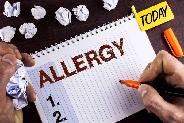 Word writing text Allergy. Business concept for damages in immunity due to hypersensitivity get it diagnised written by Man on Notepad on wooden background holding Marker Today Paper Balls. — Stock Photo, Image