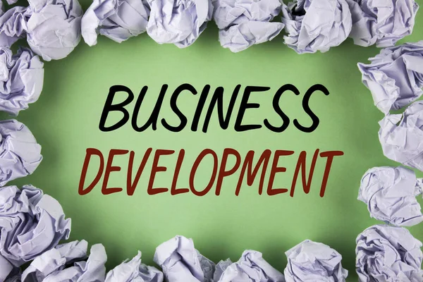 Handwriting text writing Business Development. Concept meaning Develop and Implement Organization Growth Opportunities written on plain grean background within White Paper Balls. — Stock Photo, Image