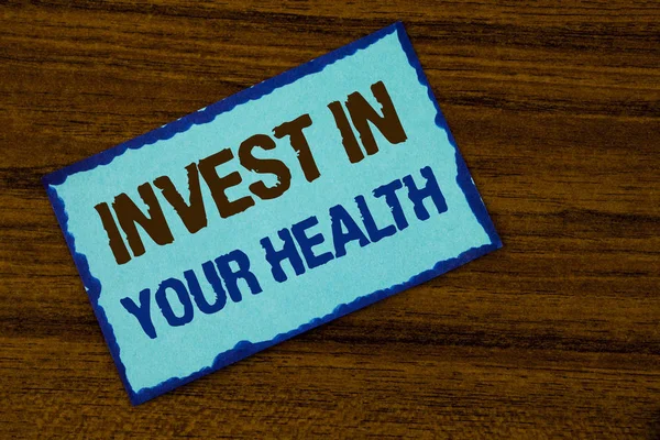 Text sign showing Invest In Your Health. Conceptual photo Spend money in personal healthcare Preventive Tests written on Sticky note paper on the Wooden background.