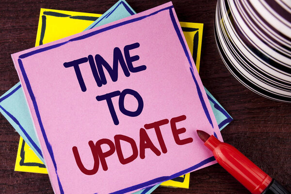 Время писать текст. Бизнес-концепция обновления Изменения необходимо Модернизация обновления написана на розовой липкой бумаге Примечание на деревянном фоне Кубок и маркер рядом с ним