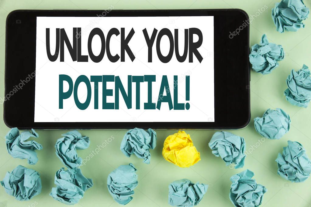 Conceptual hand writing showing Unlock Your Potential Motivational Call. Business photo text Reveal talent Sow Skills Abilities written on Mobile Phone Screen on the plain background Paper Balls.