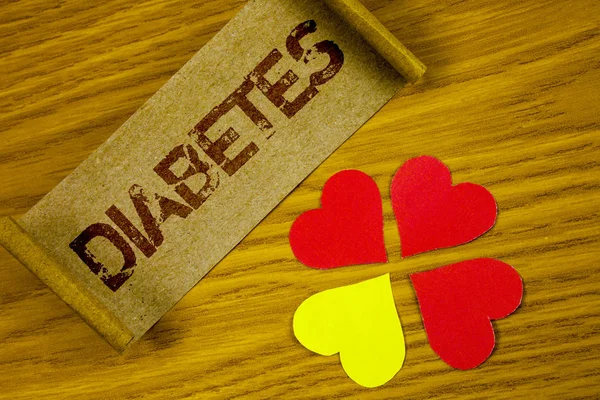 Text sign showing Diabetes. Conceptual photo Medical condition diagnosed with increased high level sugar written on Folded Cardboard Paper piece on wooden background Paper Hearts next to it — Stock Photo, Image