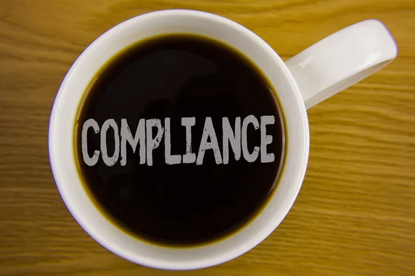 Word writing text Compliance. Business concept for Technology Company sets its policy standard regulations written on Black Tea in White Cup placed on wooden table. Top view. — Stock Photo, Image