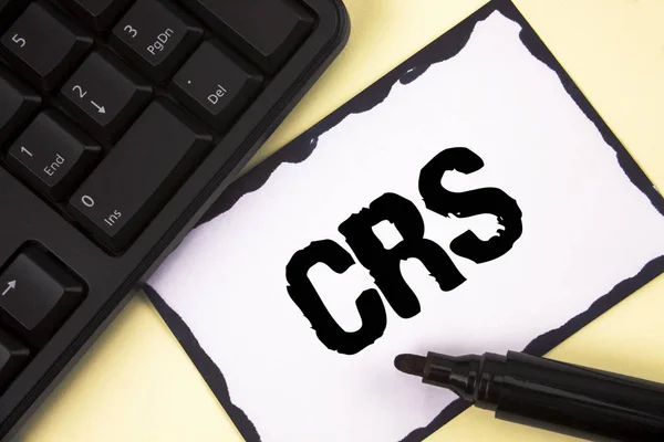 Conceptual hand writing showing Crs. Business photo text Common reporting standard for sharing tax financial information written on Sticky Note paper on plain background Marker Keyboard.