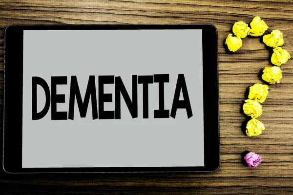 Conceptual hand writing showing Dementia. Business photo showcasing Long term memory loss sign and symptoms made me retire sooner written on Tablet Screen wooden background Paper Ball Ask for — Stock Photo, Image