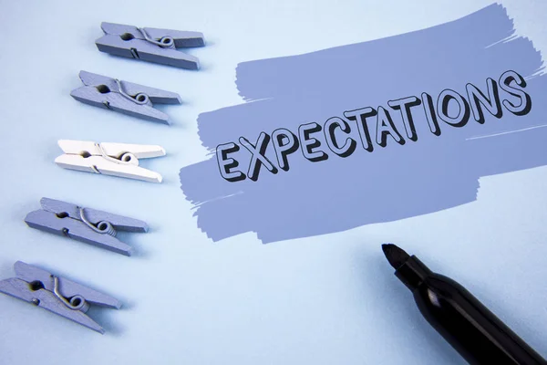 Conceptual hand writing showing Expectations. Business photo text Huge sales in equity market assumptions by an expert analyst written on Painted background wooden Clips and Marker next to it.