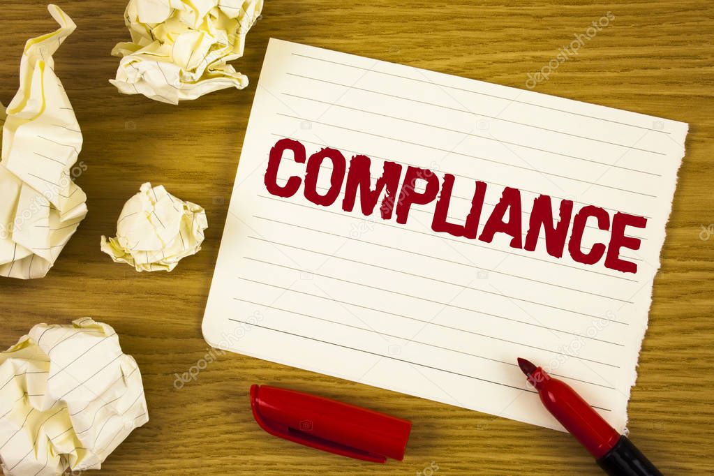 Word writing text Compliance. Business concept for Technology Company sets its policy standard regulations written on Tear Notepad paper on wooden background Marker Paper Balls next to it