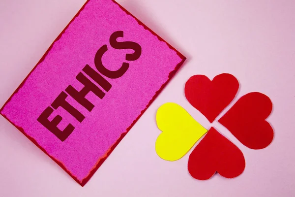 Word writing text Ethics. Business concept for Maintaining equality balance among others having moral principles written on Sticky note paper on plain Pink background Paper Hearts next to it. — Stock Photo, Image