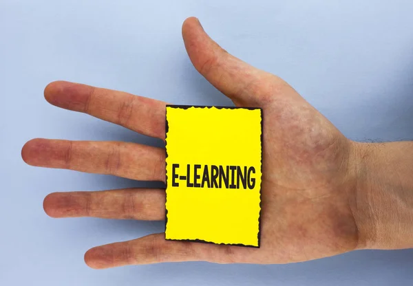 Conceptual hand writing showing E-Learning. Business photo showcasing Introduction of an electronic education in modern schools written on Yellow Sticky Note Paper on plain background Hand. — Stock Photo, Image