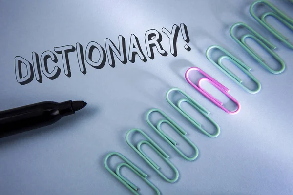 Handwriting text Dictionary Motivational Call. Concept meaning Learning another vocabs and synonyms from book written on Plain Blue background Paper Clips and Marker next to it. — Stock Photo, Image