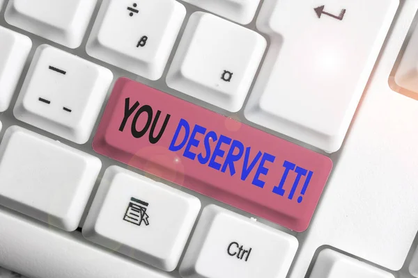 Conceptual hand writing showing You Deserve It. Business photo showcasing should have it because of their qualities or actions White pc keyboard with note paper above the white background.