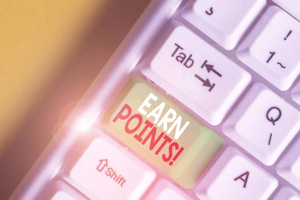 Writing note showing Earn Points. Business photo showcasing collecting scores in order qualify to win big prize White pc keyboard with note paper above the white background.