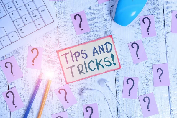 Handwriting text writing Tips And Tricks. Concept meaning means piece advice maybe suggestion how improve Writing tools, computer stuff and scribbled paper on top of wooden table. — Stock Photo, Image