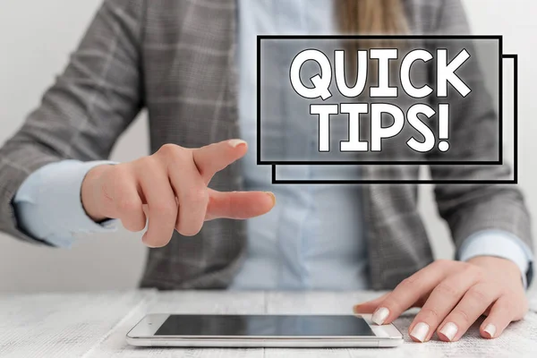 Writing note showing Quick Tips. Business photo showcasing small but particularly useful piece of practical advice Business woman sitting with mobile phone on the table.