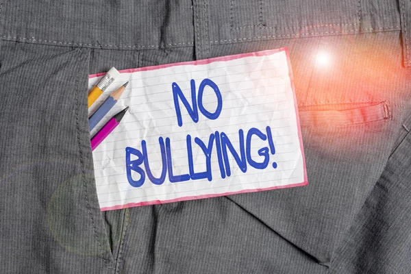 Text sign showing No Bullying. Conceptual photo stop aggressive behavior among children power imbalance Writing equipment and white note paper inside pocket of man work trousers. — Stock Photo, Image