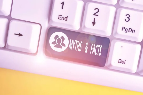 Text sign showing Myths And Facts. Conceptual photo usually traditional story of ostensibly historical events White pc keyboard with empty note paper above white background key copy space.