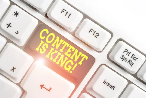 Text sign showing Content Is King. Conceptual photo marketing focused growing visibility non paid search results White pc keyboard with empty note paper above white background key copy space.