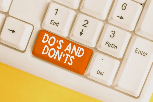 Text sign showing Do S And Don tS. Conceptual photo Rules or customs concerning some activity or actions White pc keyboard with empty note paper above white background key copy space.