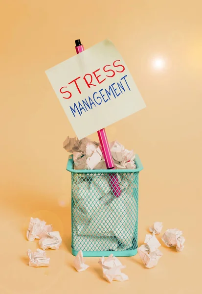 Writing note showing Stress Management. Business photo showcasing method of limiting stress and its effects by learning ways crumpled paper and stationary with paper placed in the trash can.