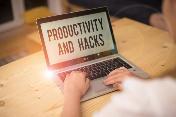 Writing note showing Productivity Hacks. Business photo showcasing tricks that you get more done in the same amount of time woman with laptop smartphone and office supplies technology.