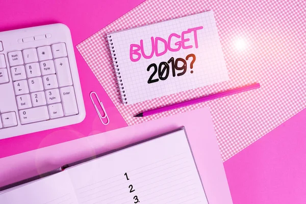 A 2019-es költségvetés kérdését bemutató írásbeli feljegyzés. Üzleti fotó bemutatása becsült bevétel és kiadások a következő évre Íróeszközök és számítógépes cucc felett elhelyezett színes sima asztal. — Stock Fotó